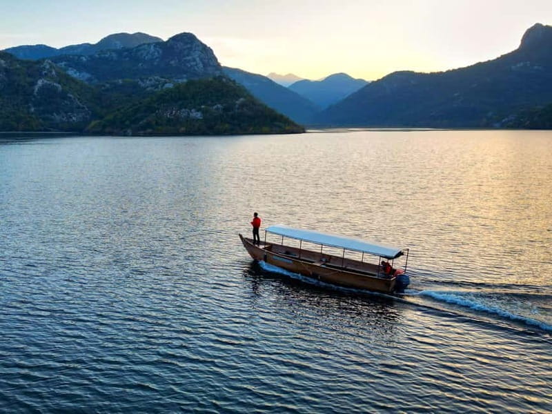 Skadar Lake: Guided Sunset Boat Tour with Wooden Boat & Wine - Golden hour on Skadar Lake, with a traditional wooden boat from Virpazar
